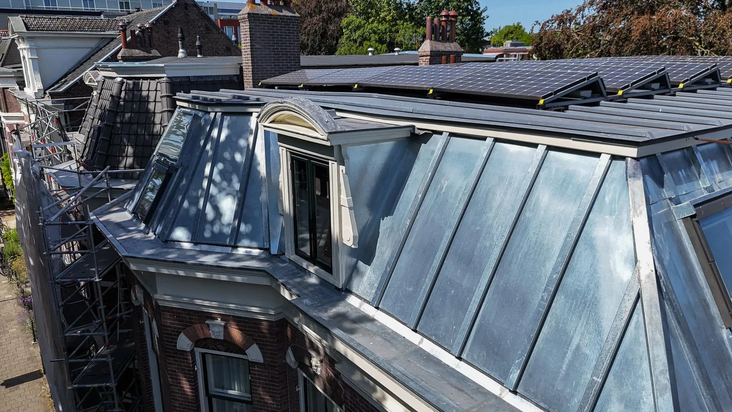 Zinken dakvlakken en dakkapel van dichtbij aan de Baan in Haarlem